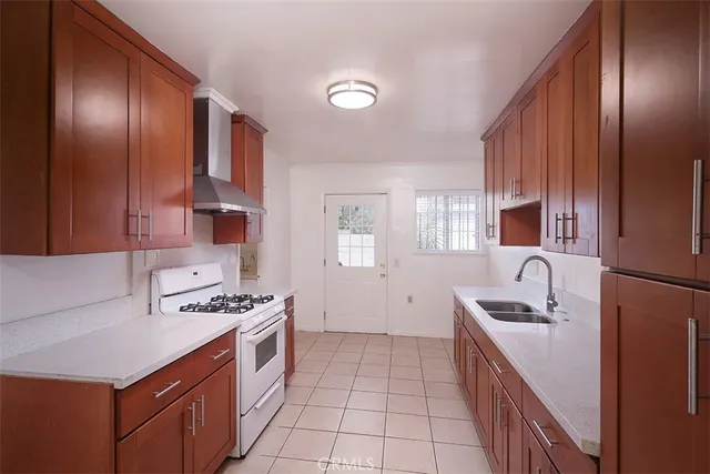 a kitchen with stainless steel appliances a sink stove and refrigerator