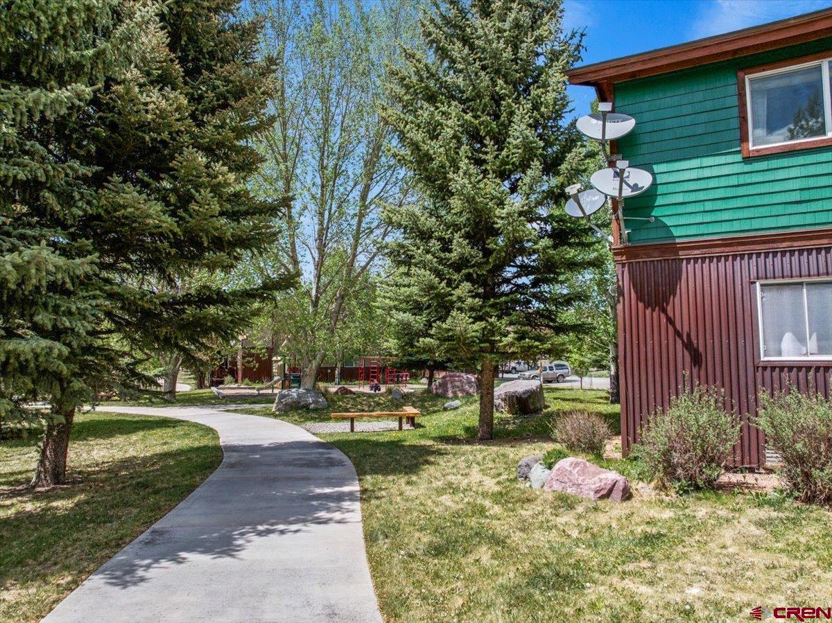 520 Redcliff Circle, Unit G203 Ridgway, CO 81432 - Photo 20 of 25 a front view of a house with a yard