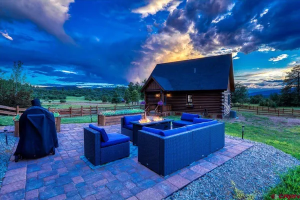 a view of a patio with couches chairs and a fire pit