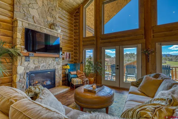 a living room with furniture a fireplace and a flat screen tv