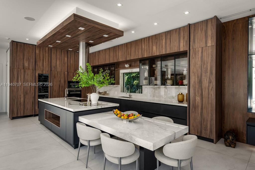 6850 Southwest 73rd Court Miami, FL 33143 - Photo 11 of 52 a kitchen with stainless steel appliances granite countertop a stove refrigerator and cabinets