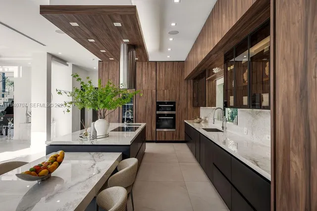 a dining hall with granite countertop kitchen island stainless steel appliances a sink and living room view