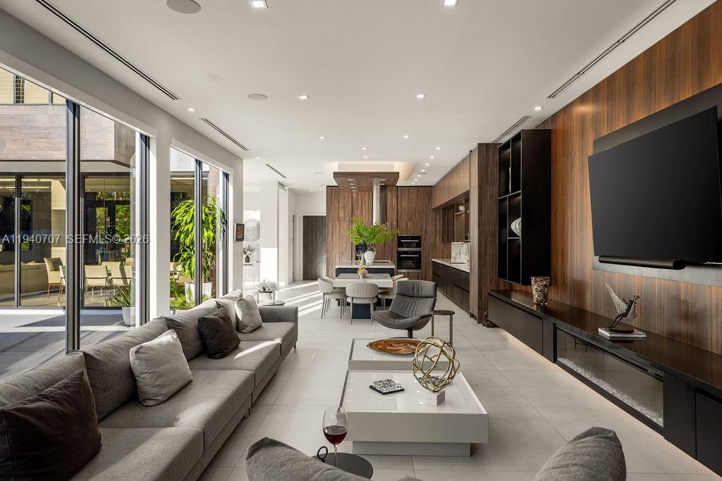 6850 Southwest 73rd Court Miami, FL 33143 - Photo 15 of 52 a living room with furniture flat screen tv and a large window