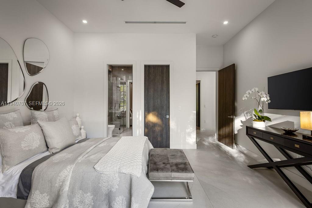 6850 Southwest 73rd Court Miami, FL 33143 - Photo 17 of 52 a bedroom with a bed and a flat screen tv