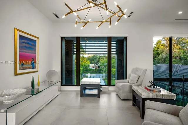 a living room with furniture and floor to ceiling window