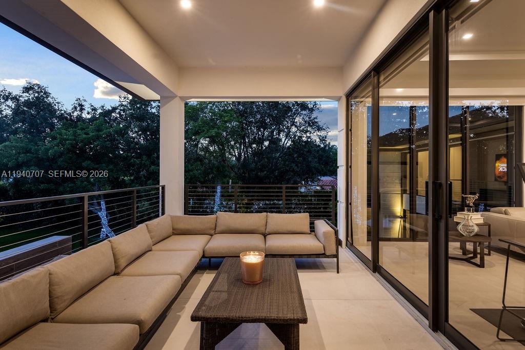 6850 Southwest 73rd Court Miami, FL 33143 - Photo 24 of 52 a balcony with furniture and a floor to ceiling window