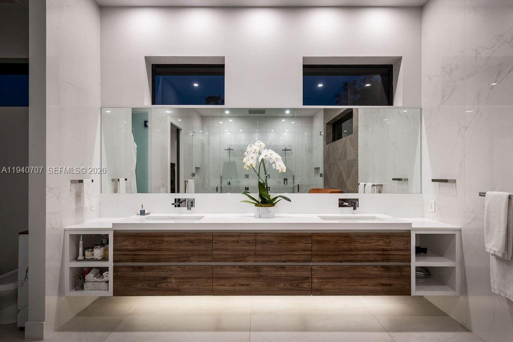 6850 Southwest 73rd Court Miami, FL 33143 - Photo 25 of 52 a bathroom with double vanity and a mirror