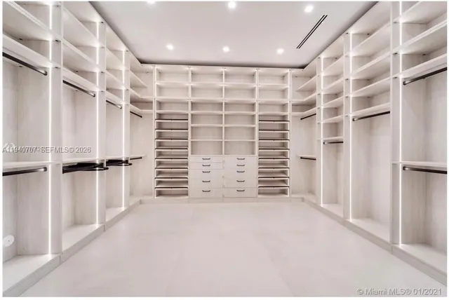 a view of walk in closet with empty racks