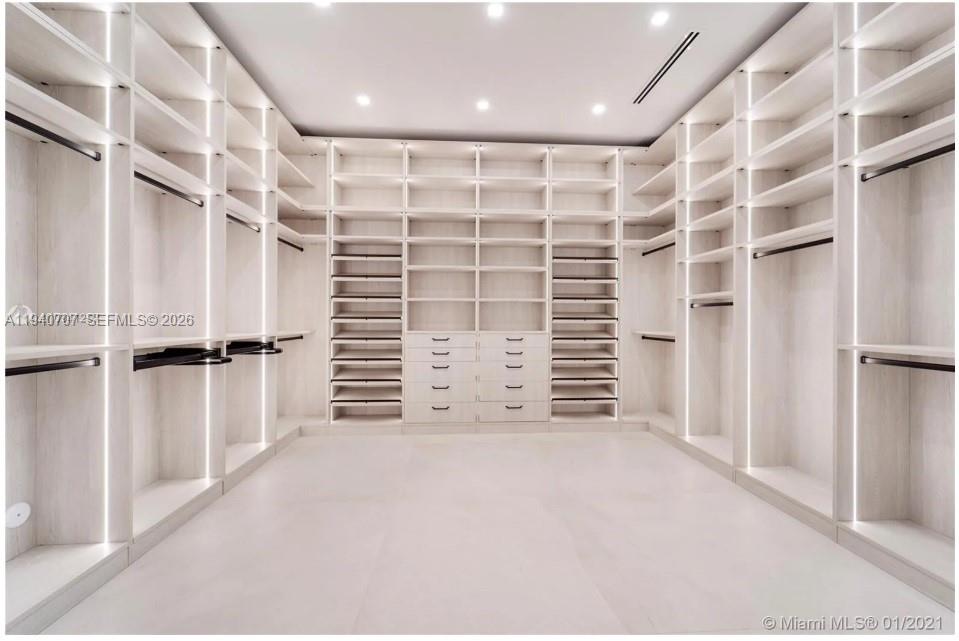 6850 Southwest 73rd Court Miami, FL 33143 - Photo 26 of 52 a view of walk in closet with empty racks