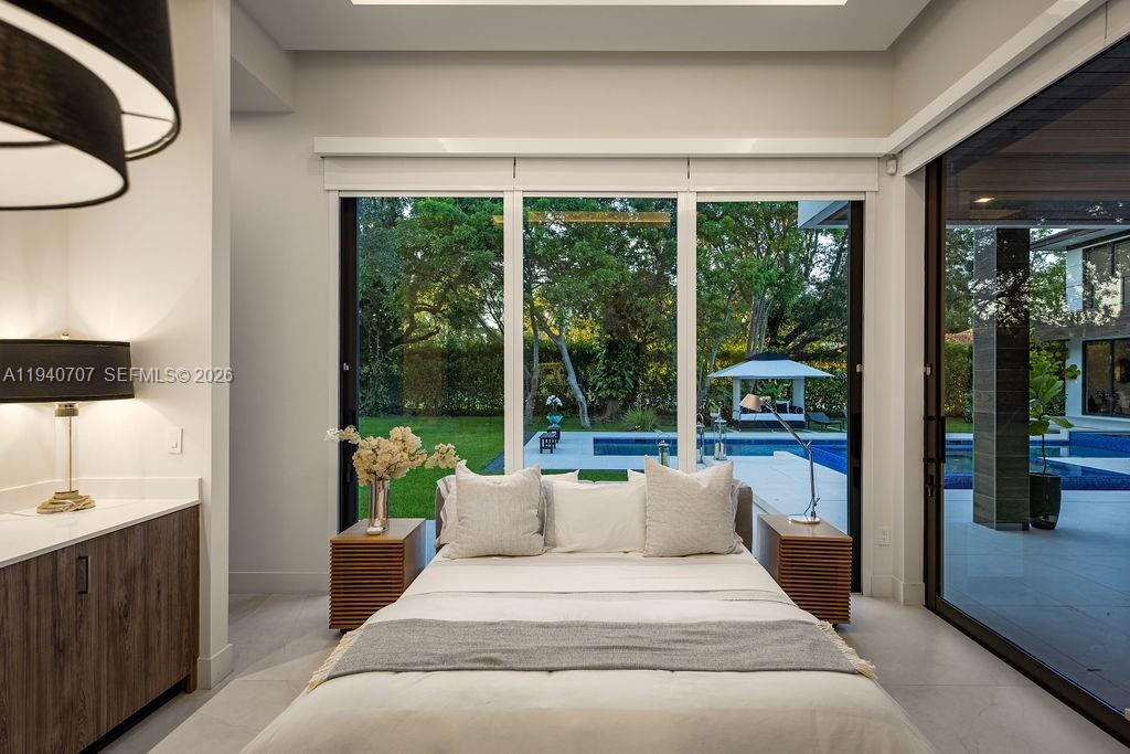 6850 Southwest 73rd Court Miami, FL 33143 - Photo 27 of 52 a bedroom with a large bed and a balcony