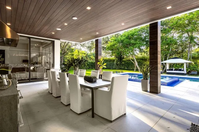 a dining room with furniture and a garden