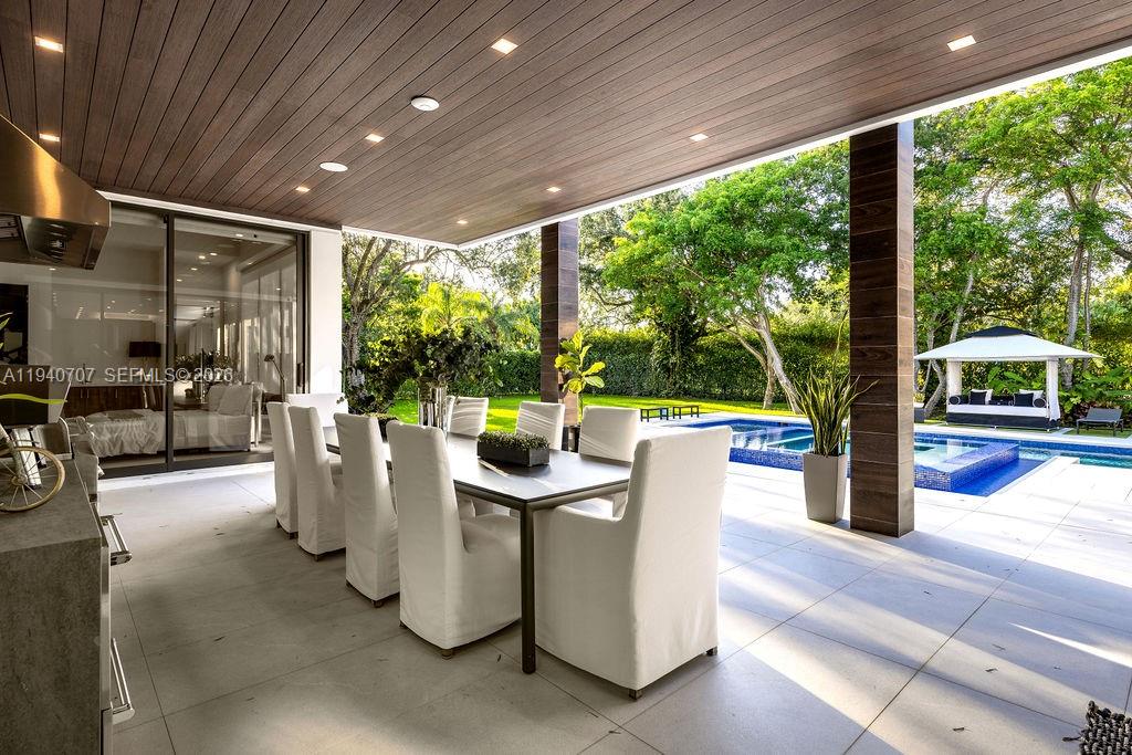 6850 Southwest 73rd Court Miami, FL 33143 - Photo 29 of 52 a dining room with furniture and a garden
