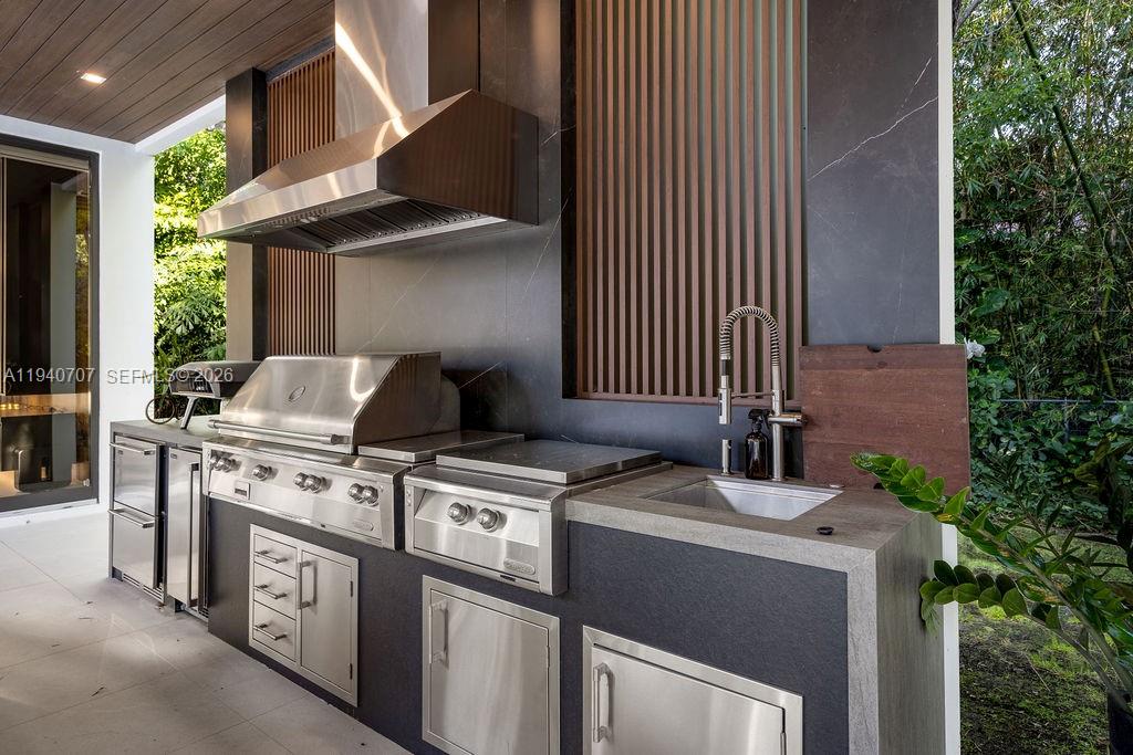 6850 Southwest 73rd Court Miami, FL 33143 - Photo 30 of 52 a kitchen with a stove and a microwave