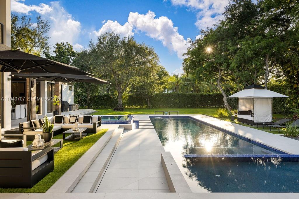 6850 Southwest 73rd Court Miami, FL 33143 - Photo 32 of 52 a view of a swimming pool with a patio