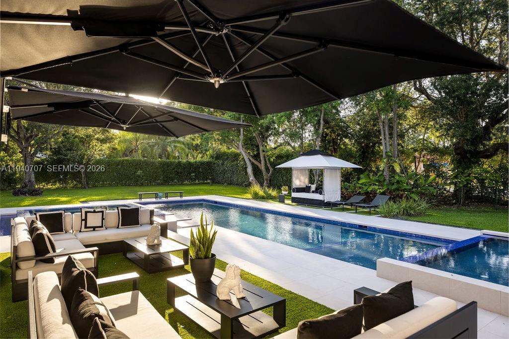 6850 Southwest 73rd Court Miami, FL 33143 - Photo 33 of 52 a view of an outdoor sitting area with furniture and umbrella