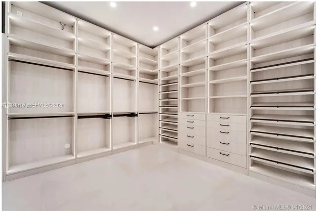 a view of walk in closet with empty racks