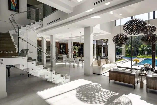 a living room with lots of furniture and a chandelier