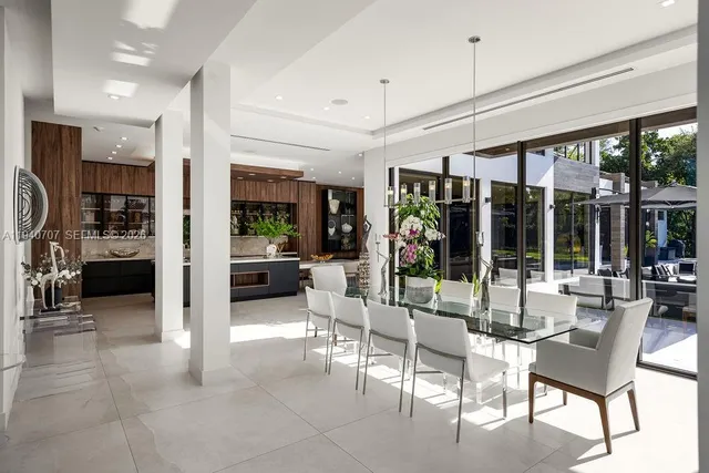a view of a livingroom with furniture and floor to ceiling window