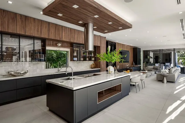 a kitchen with stainless steel appliances granite countertop a sink and a stove