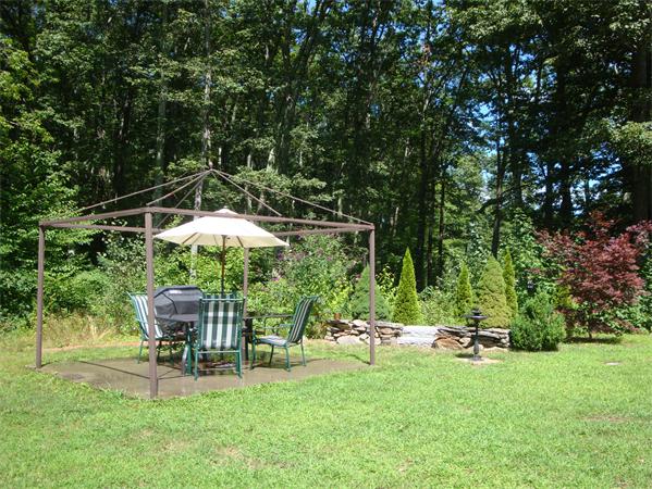 72 King Road Charlton, MA 01507 - Photo 18 of 24 a backyard of a house with table and chairs