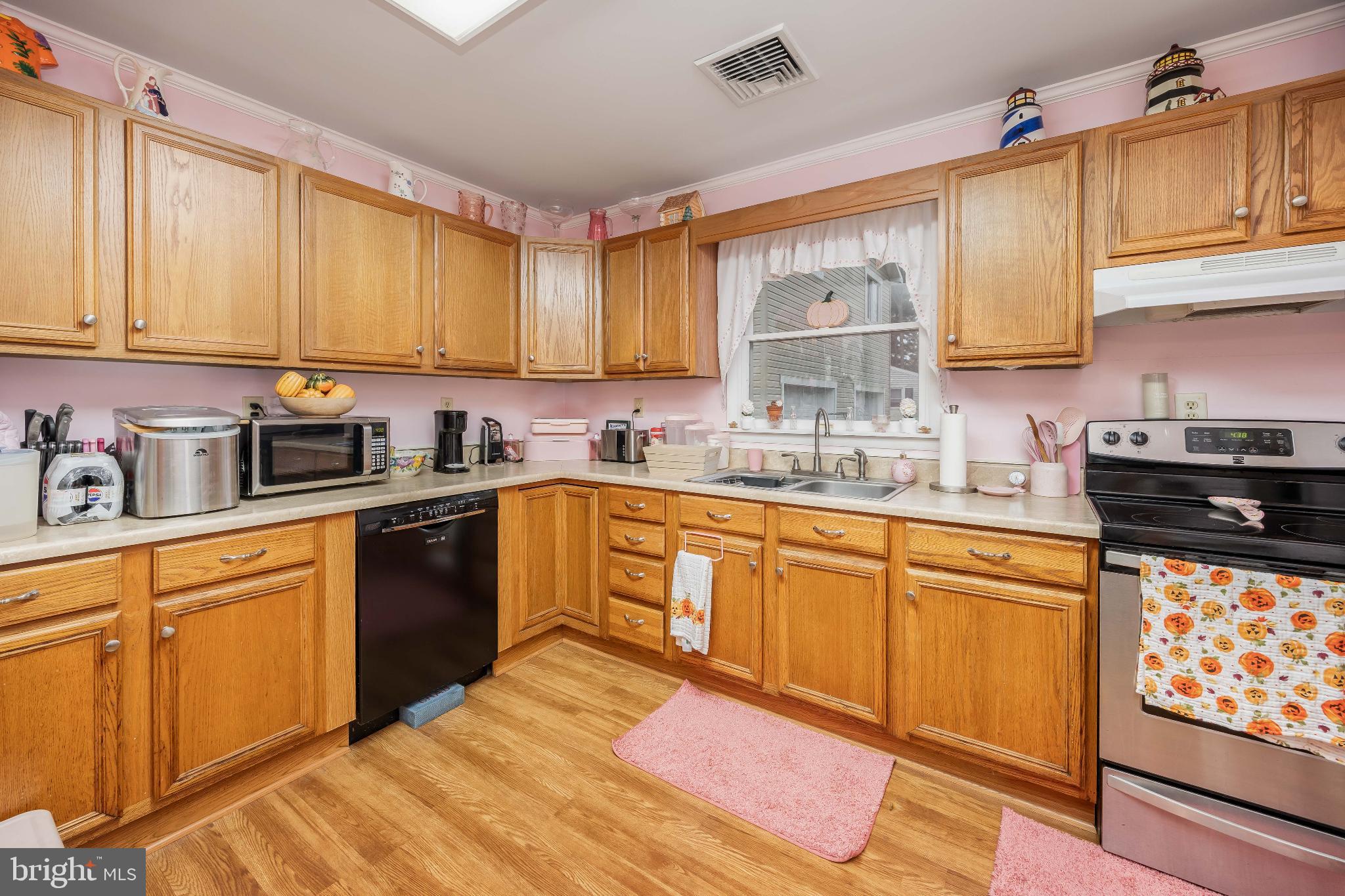 136 Marvel Road Salisbury, MD 21801 - Photo 8 of 42 a kitchen with stainless steel appliances granite countertop a sink dishwasher stove and cabinets with wooden floor