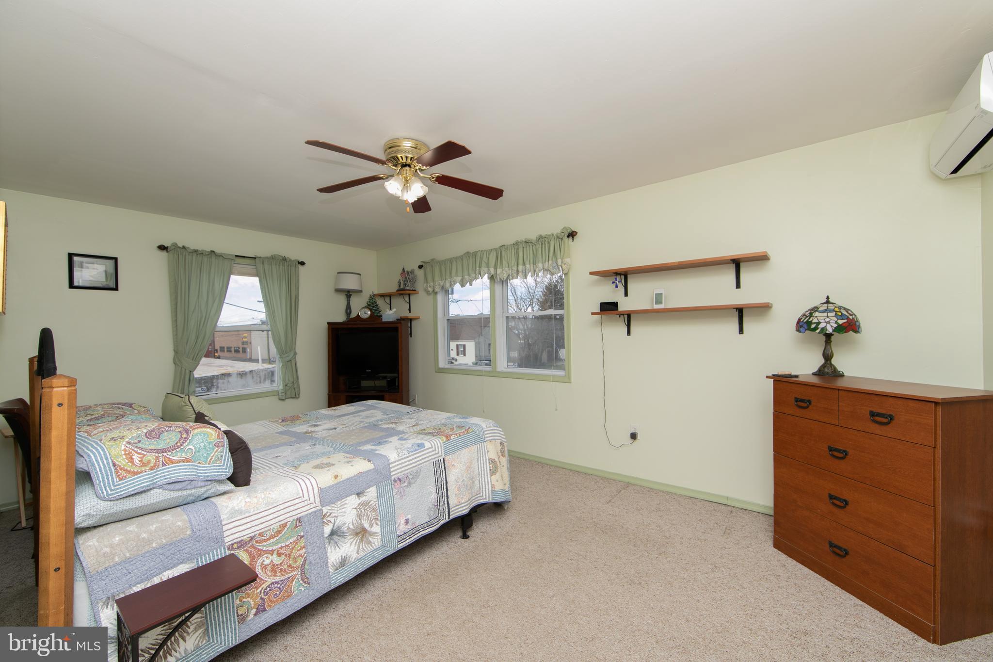 614 West 5th Street Palmyra, NJ 08065 - Photo 25 of 30 a bedroom with a large bed and a chandelier