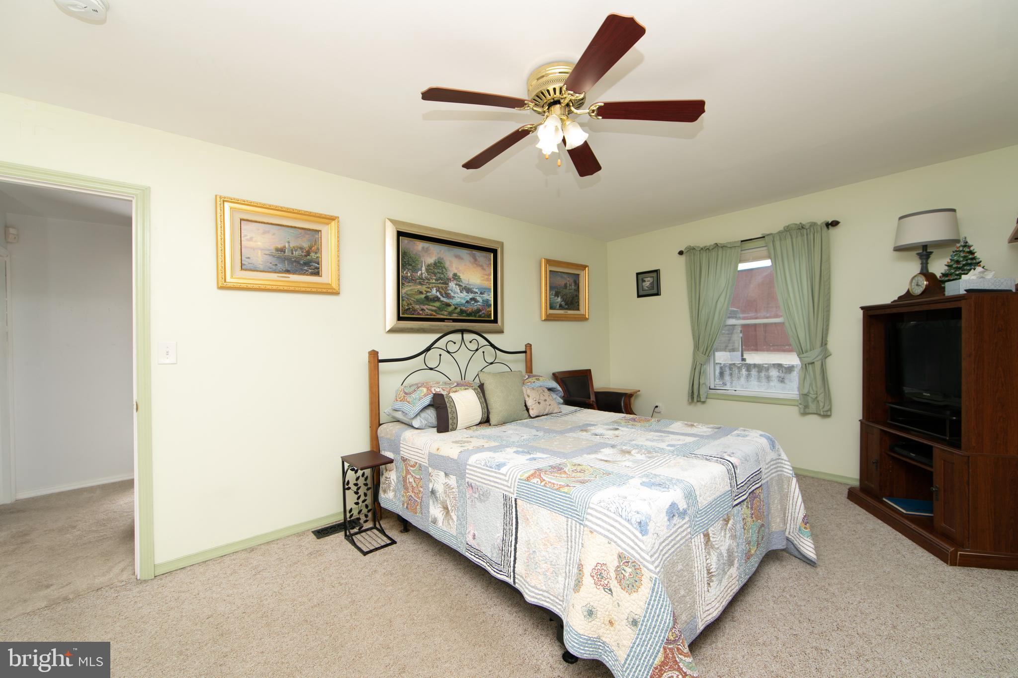 614 West 5th Street Palmyra, NJ 08065 - Photo 26 of 30 a bedroom with a bed and a flat screen tv