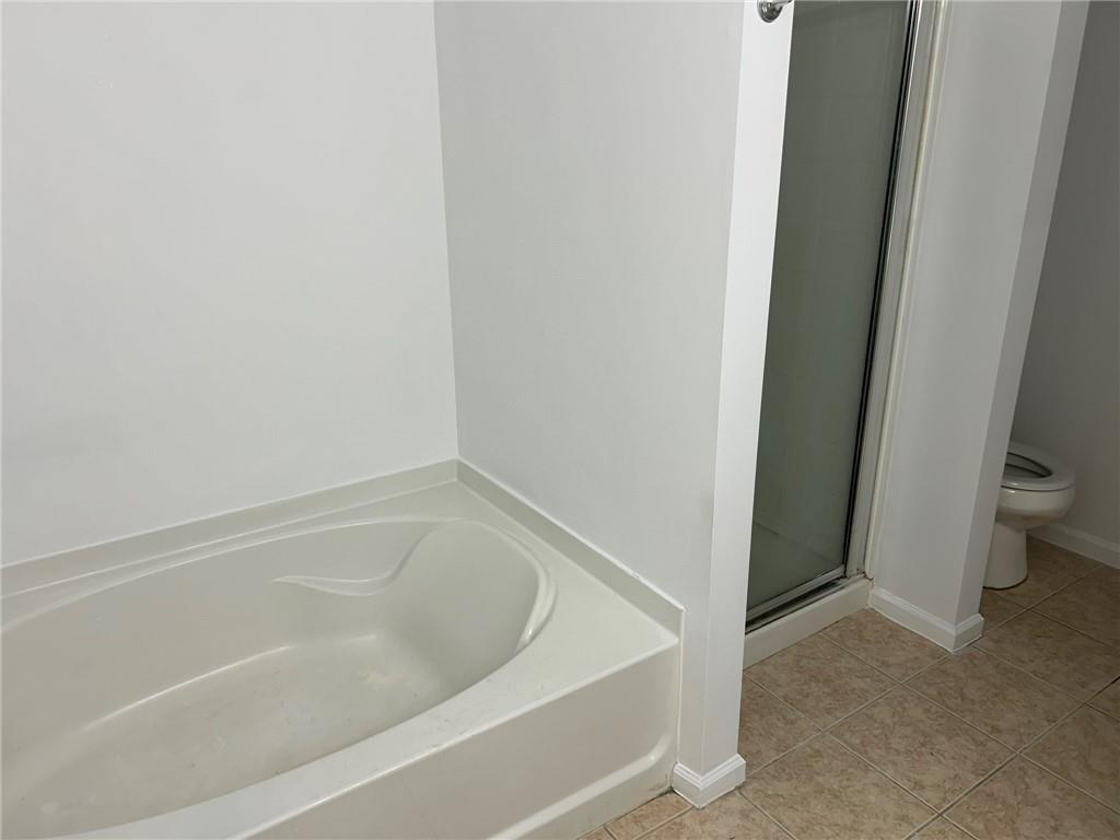 2099 Meadow Peak Road Duluth, GA 30097 - Photo 4 of 13 a white bath tub sitting next to a white toilet