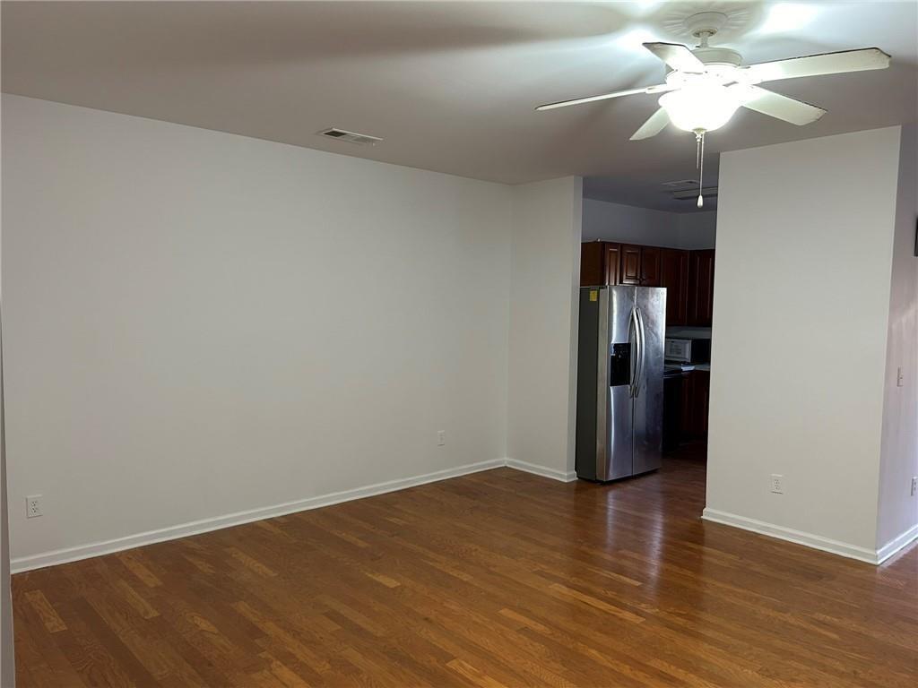 2099 Meadow Peak Road Duluth, GA 30097 - Photo 7 of 13 a view of a room with wooden floor and a ceiling fan