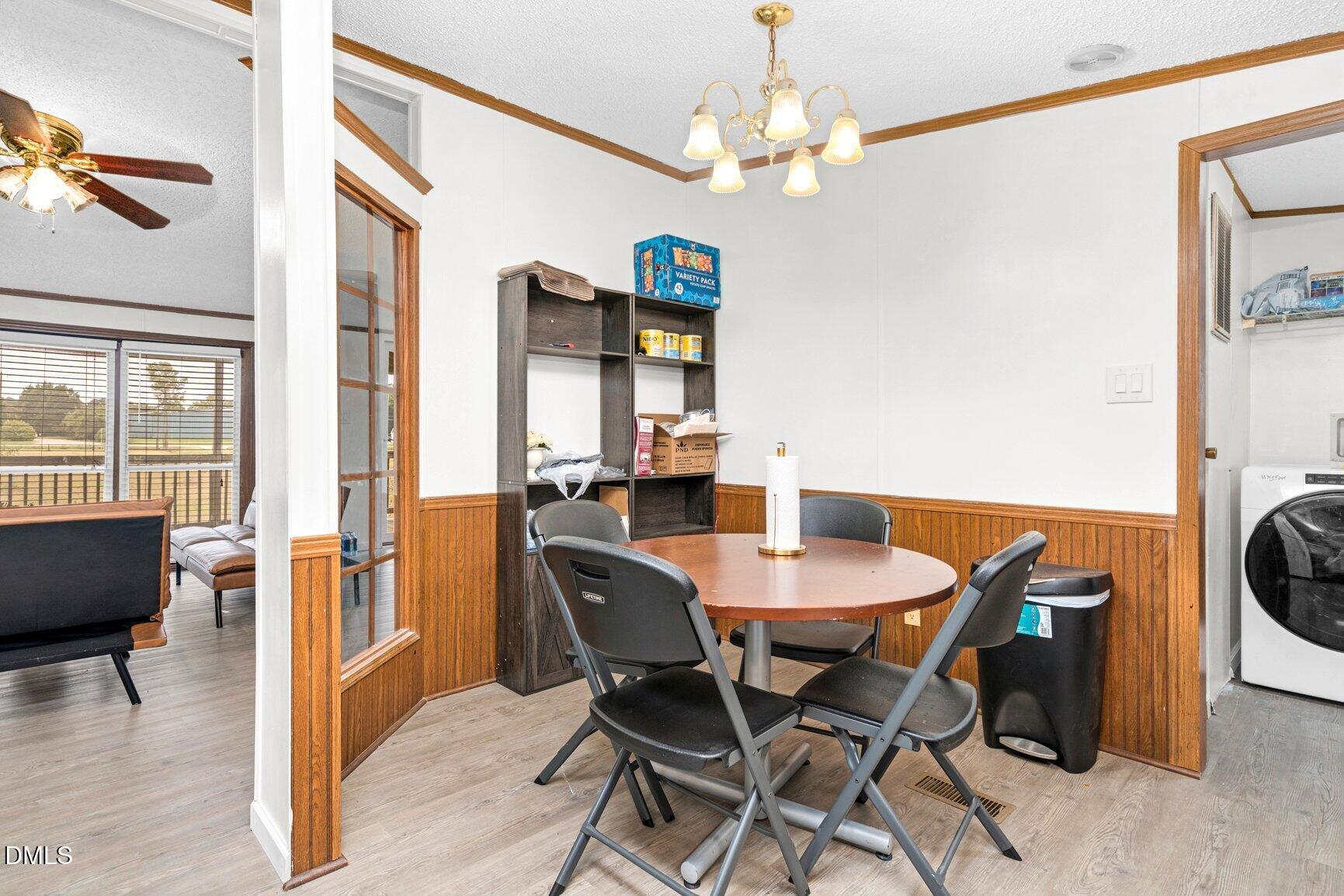 1835 Cokey Road Rocky Mount, NC 27801 - Photo 12 of 42 a view of a dining room with furniture wooden floor and chandelier
