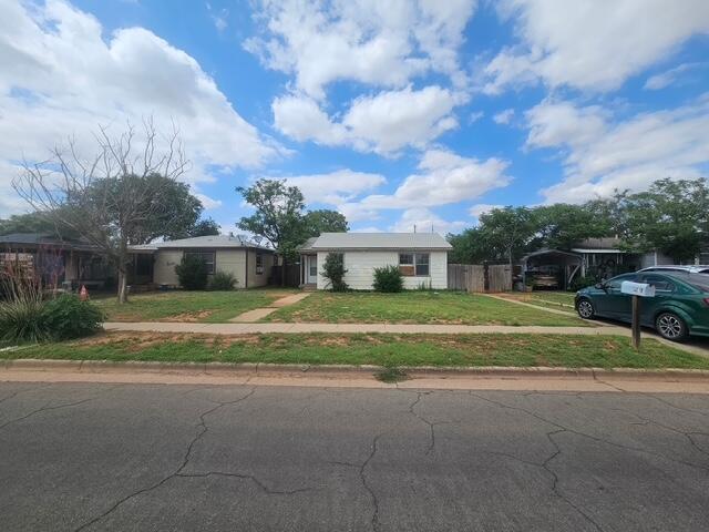 3218 Colgate Street Lubbock, TX 79415 - Photo 1 of 6 a front view of house with yard and green space