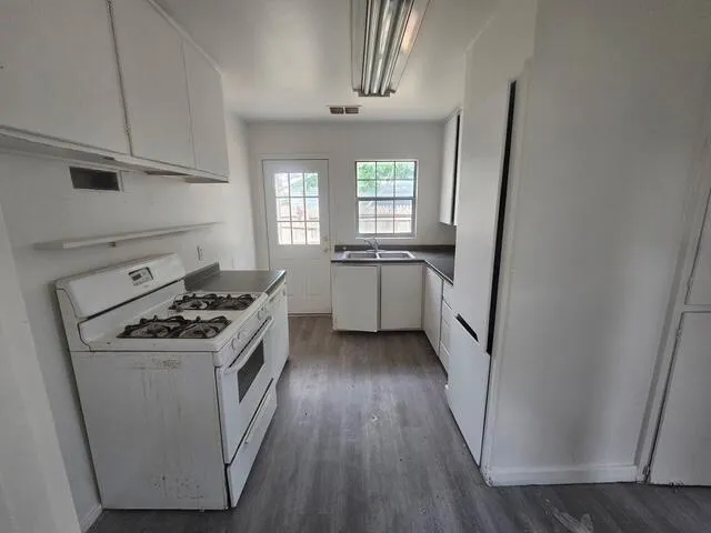 a kitchen with sink a stove and refrigerator