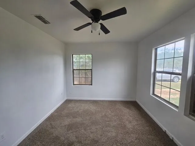 a view of empty room with windows