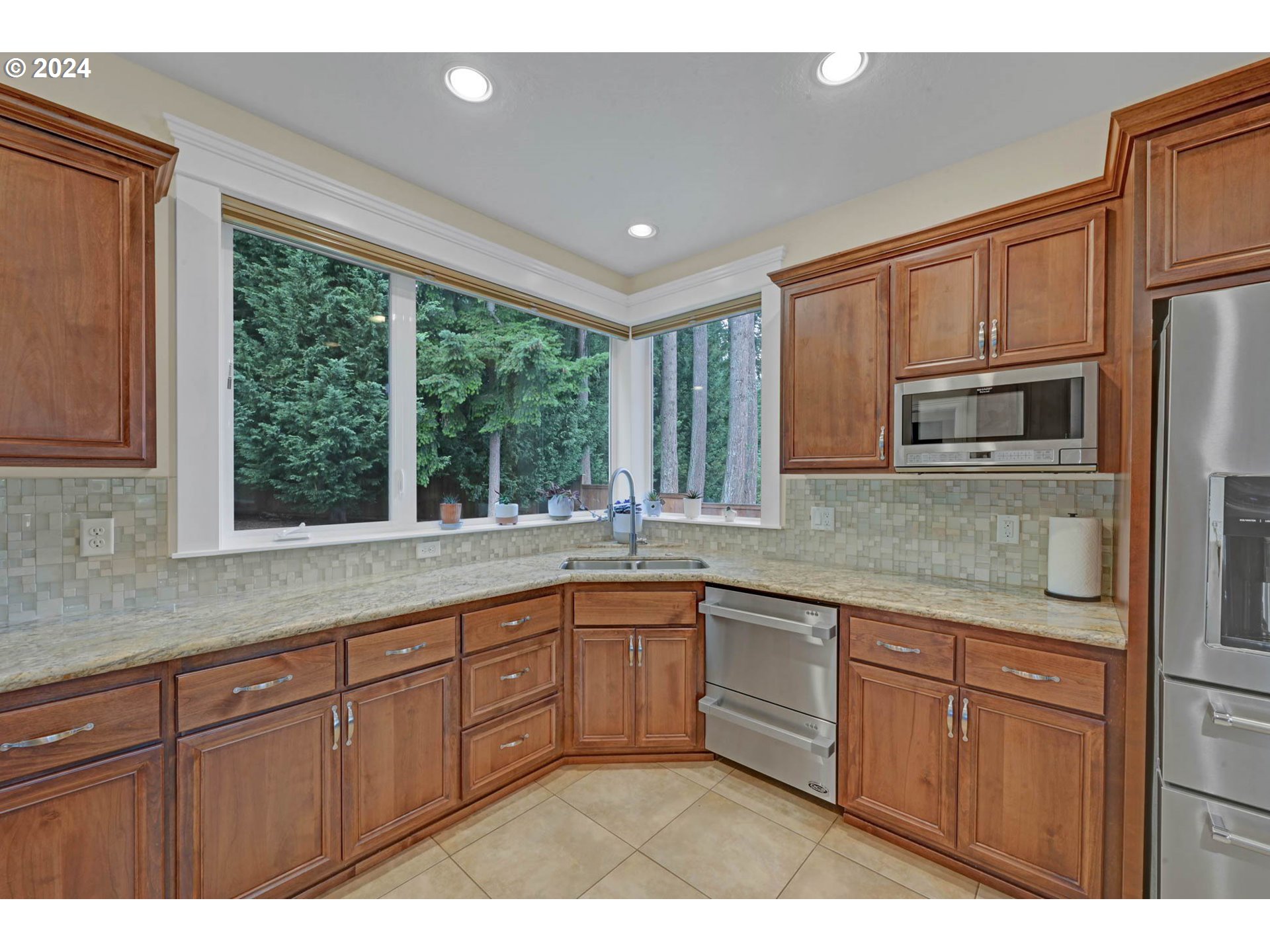 3587 Summit Sky Boulevard Eugene, OR 97405 - Photo 14 of 45 a kitchen with stainless steel appliances granite countertop a sink and large window