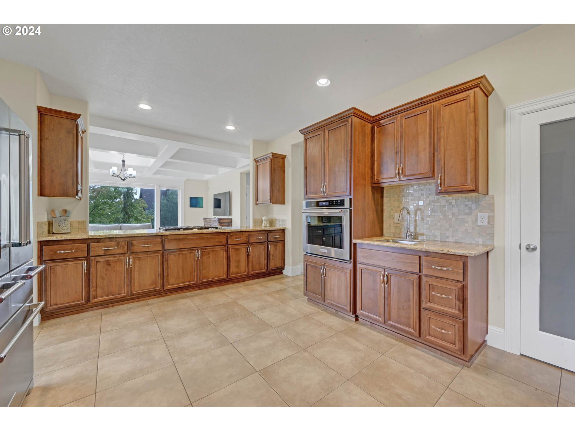 3587 Summit Sky Boulevard Eugene, OR 97405 - Photo 16 of 45 a large kitchen with kitchen island granite countertop a large counter top space a sink stainless steel appliances and cabinets