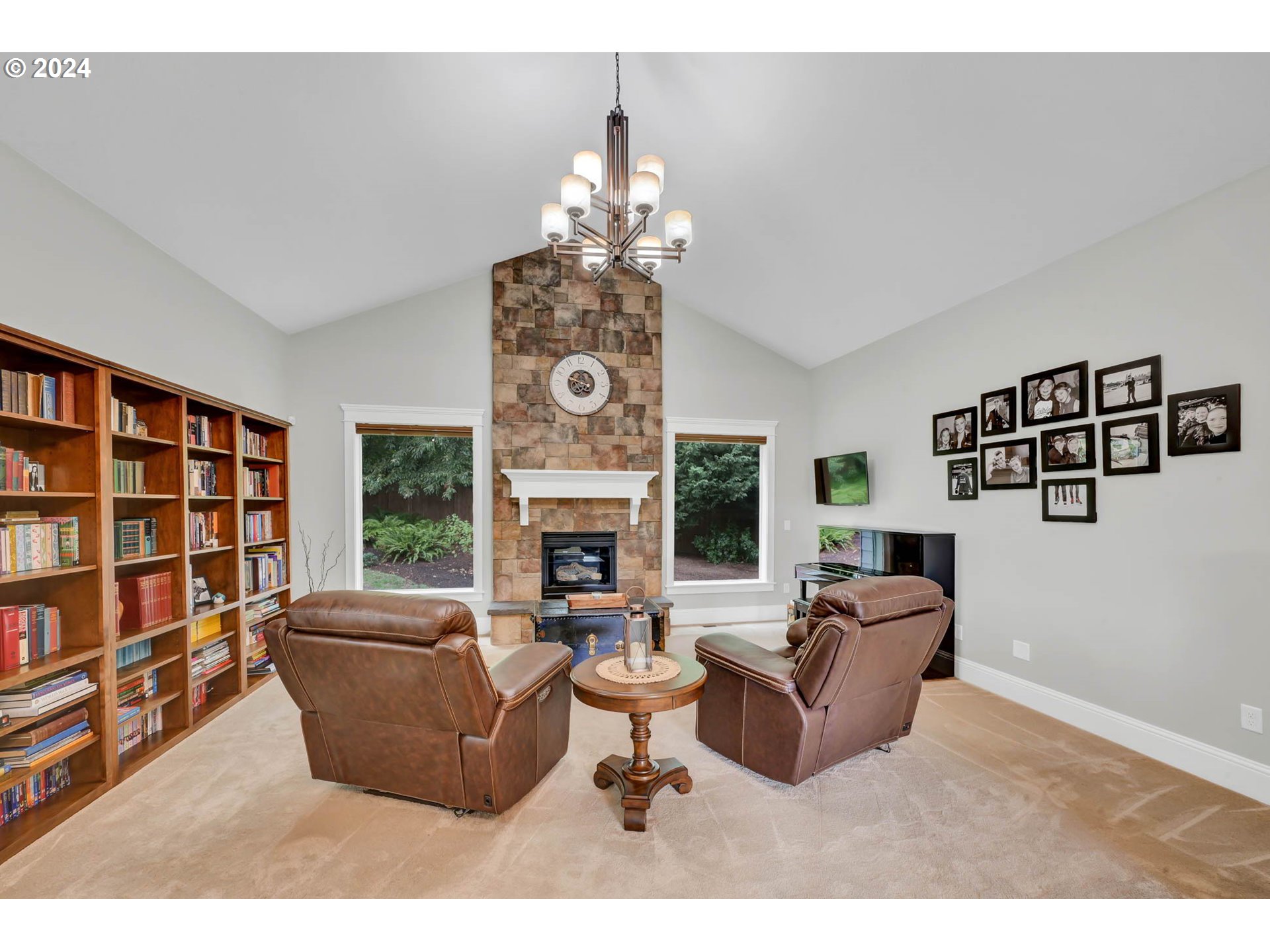 3587 Summit Sky Boulevard Eugene, OR 97405 - Photo 24 of 45 a living room with furniture a fireplace and a chandelier