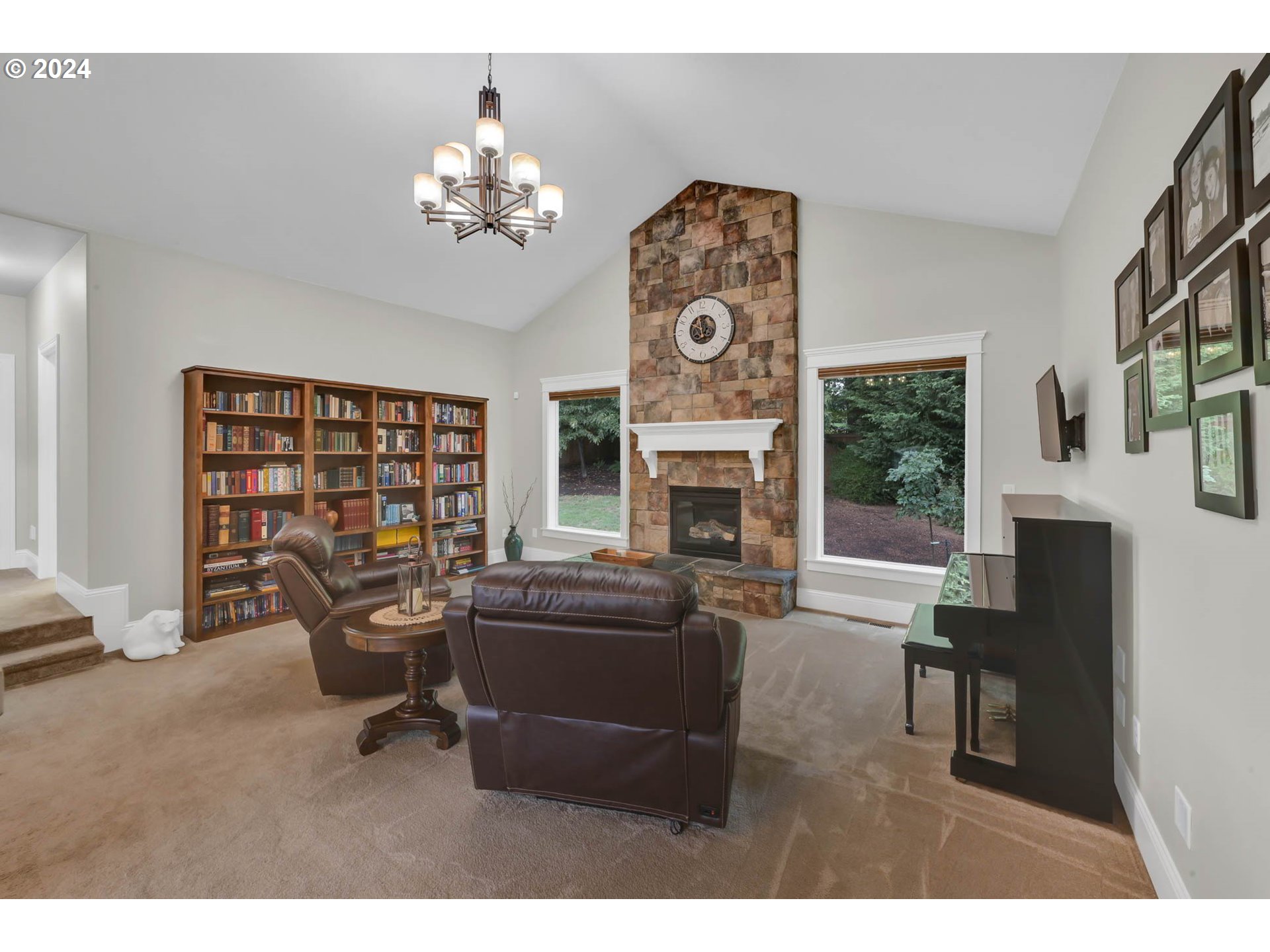 3587 Summit Sky Boulevard Eugene, OR 97405 - Photo 25 of 45 a living room with furniture a fireplace and a chandelier