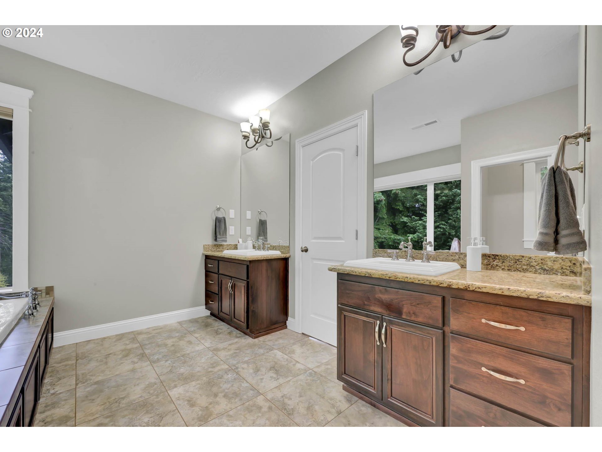 3587 Summit Sky Boulevard Eugene, OR 97405 - Photo 33 of 45 a bathroom with a granite countertop sink a toilet a mirror and shower
