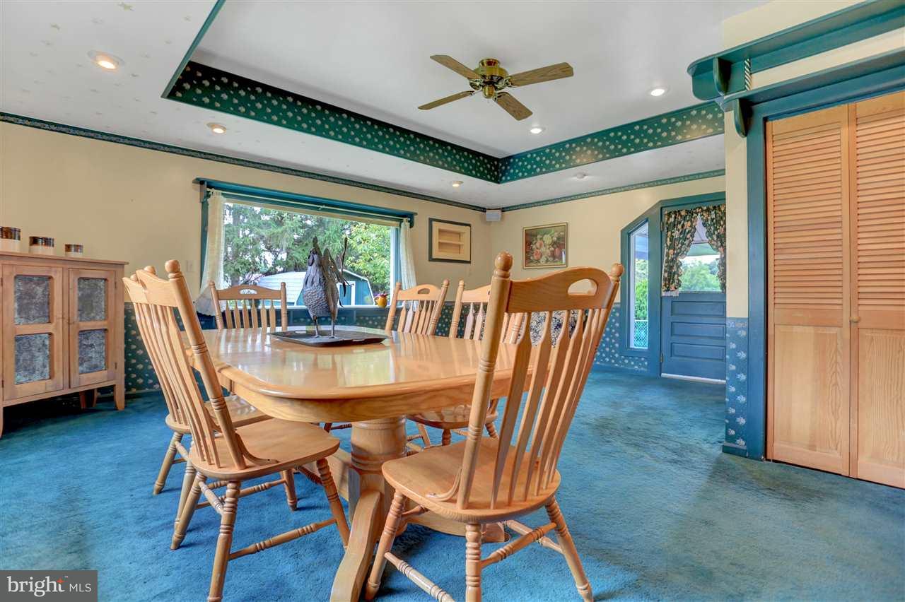 2238 Sycamore Road York, PA 17408 - Photo 16 of 32 a dining room with furniture a chandelier and wooden floor