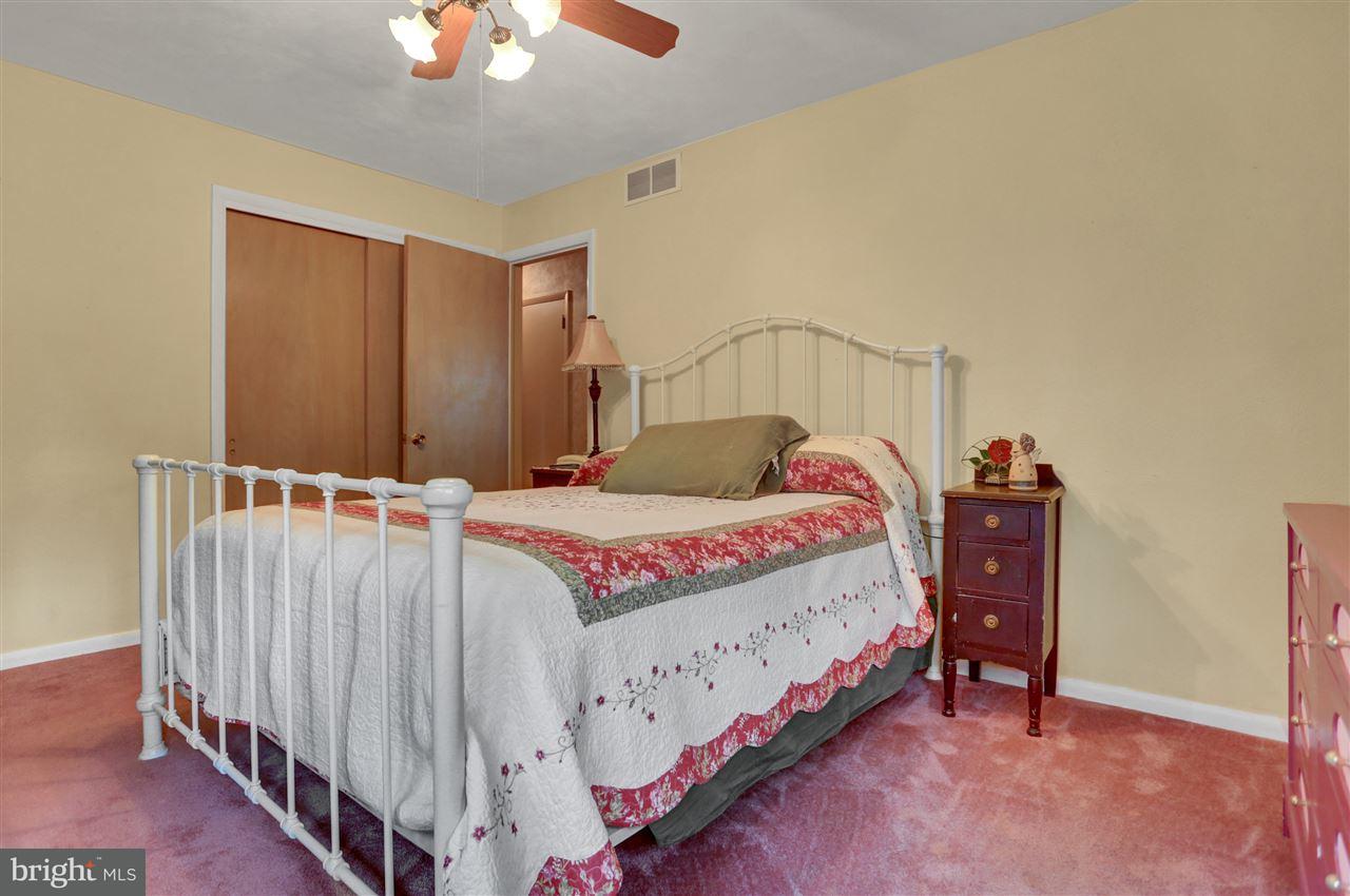 2238 Sycamore Road York, PA 17408 - Photo 18 of 32 a bedroom with a bed and a chandelier