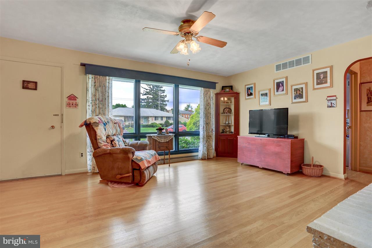 2238 Sycamore Road York, PA 17408 - Photo 6 of 32 a living room with furniture a flat screen tv and a large window