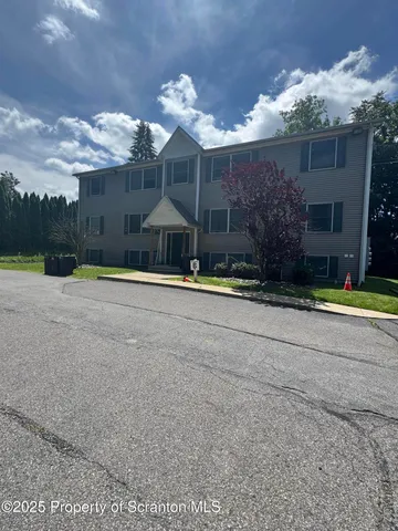 a view of a house with a yard and a garage