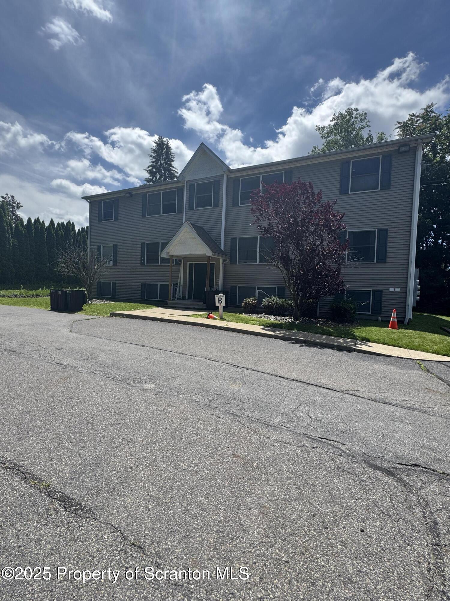 131 Smith Street, Unit 6 Dunmore, PA 18512 - Photo 1 of 13 a view of a house with a yard and a garage