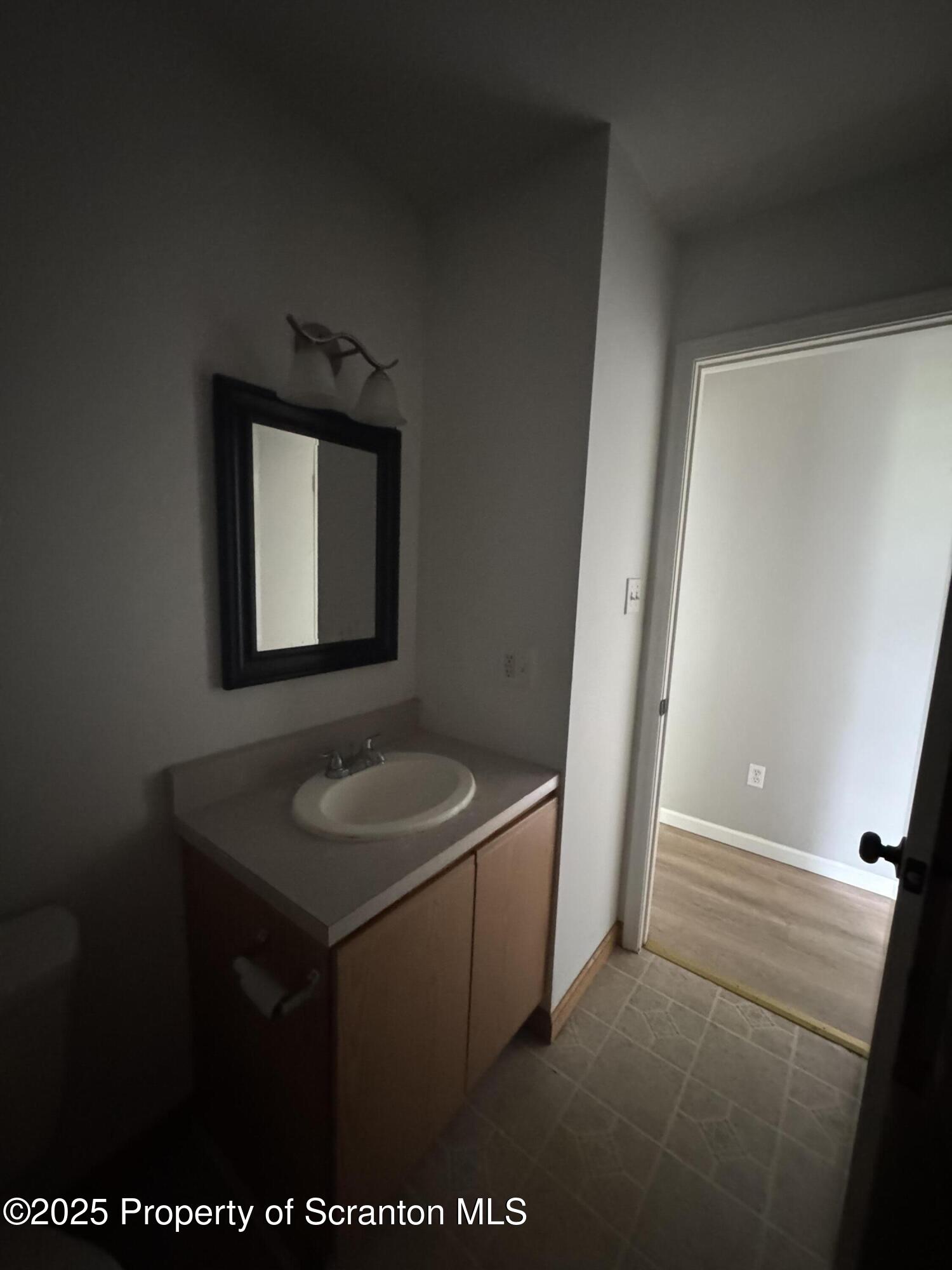 131 Smith Street, Unit 6 Dunmore, PA 18512 - Photo 12 of 13 a bathroom with a granite countertop sink and a mirror