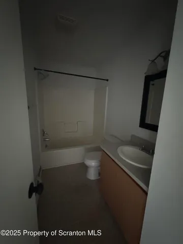 a bathroom with a granite countertop sink