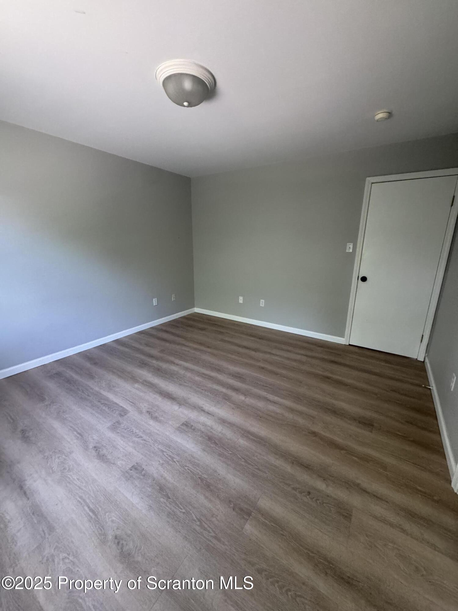 131 Smith Street, Unit 6 Dunmore, PA 18512 - Photo 3 of 13 a view of an empty room with wooden floor