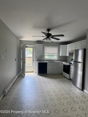 a view of a kitchen with a sink stainless steel appliances