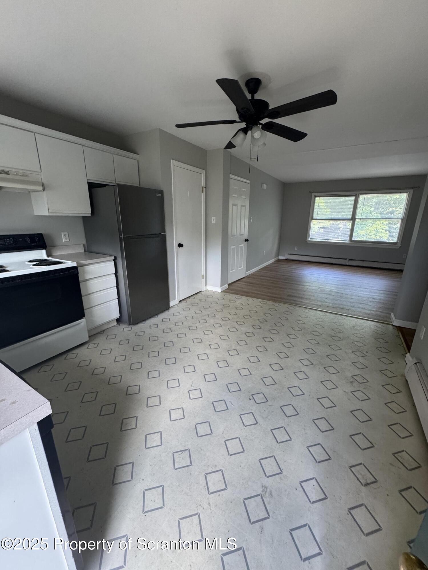 131 Smith Street, Unit 6 Dunmore, PA 18512 - Photo 6 of 13 a large kitchen with cabinets and wooden floor