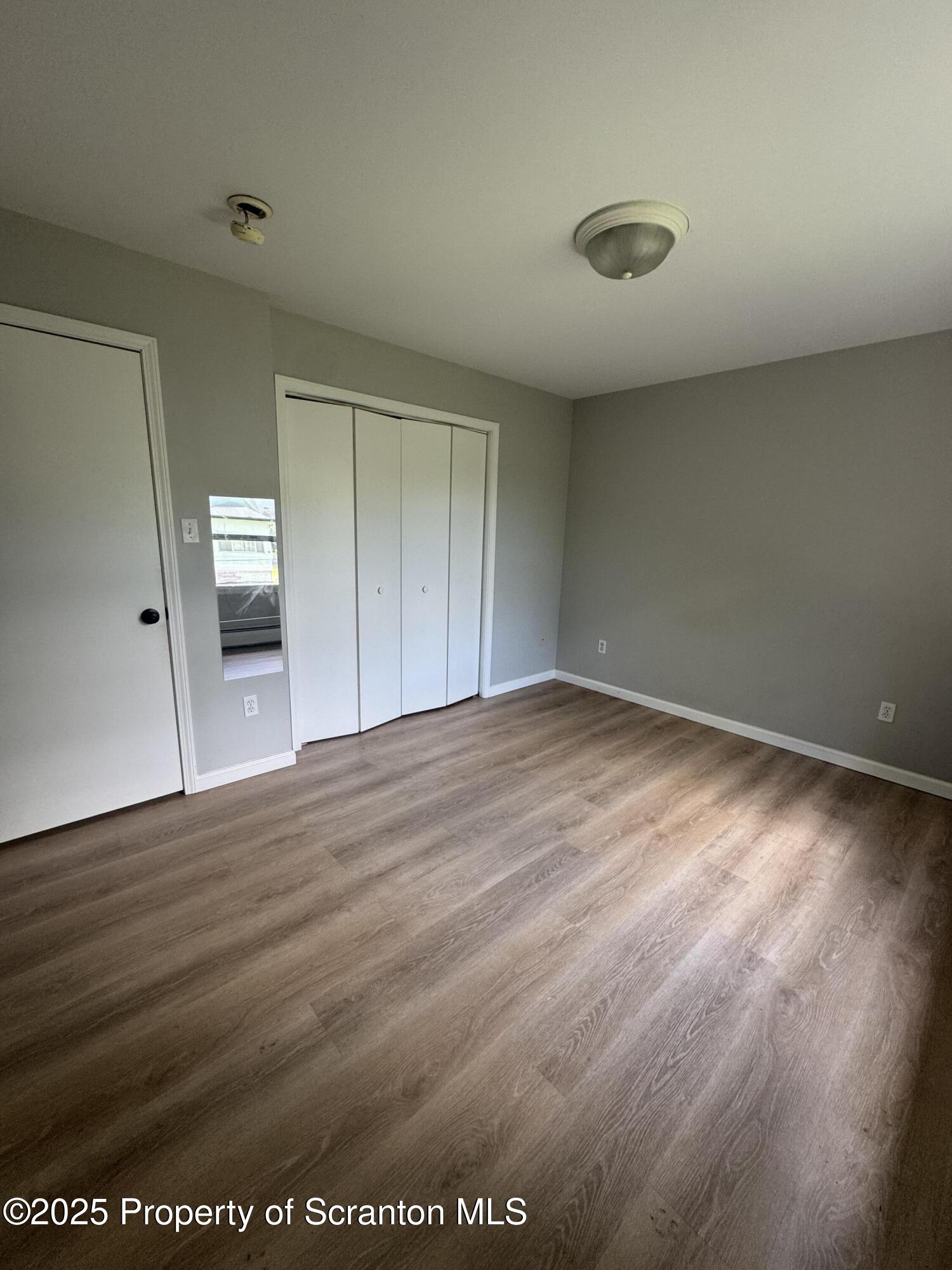 131 Smith Street, Unit 6 Dunmore, PA 18512 - Photo 10 of 13 a view of empty room with wooden floor