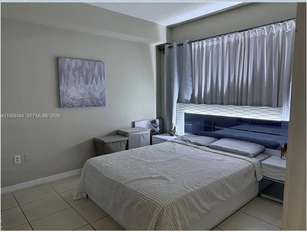 a bedroom with a bed and a wall painting